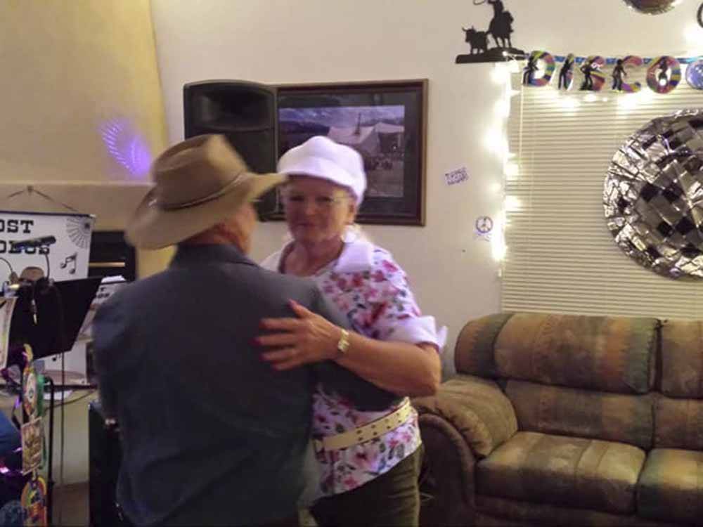 A couple dancing to music at PATO BLANCO LAKES RV RESORT