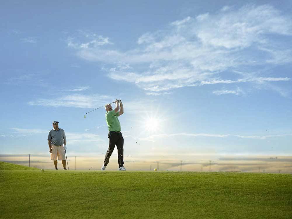 A couple of people playing golf at WILDHORSE RESORT & CASINO RV PARK