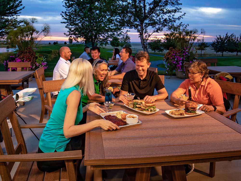 A group of people eating at a table at WILDHORSE RESORT & CASINO RV PARK