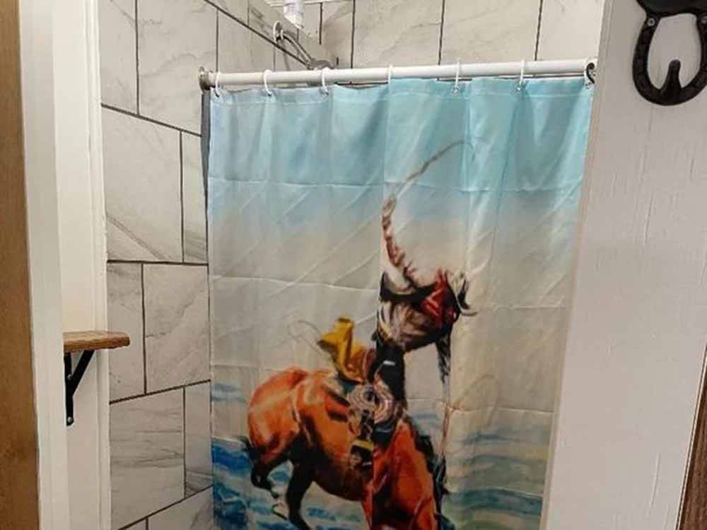 A cowboy shower curtain at RESTWAY TRAVEL PARK