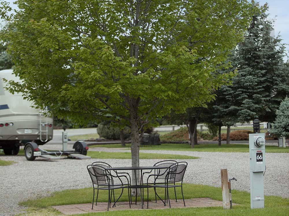 A table with chairs next to site 66 at COLUMBIA FALLS RV PARK