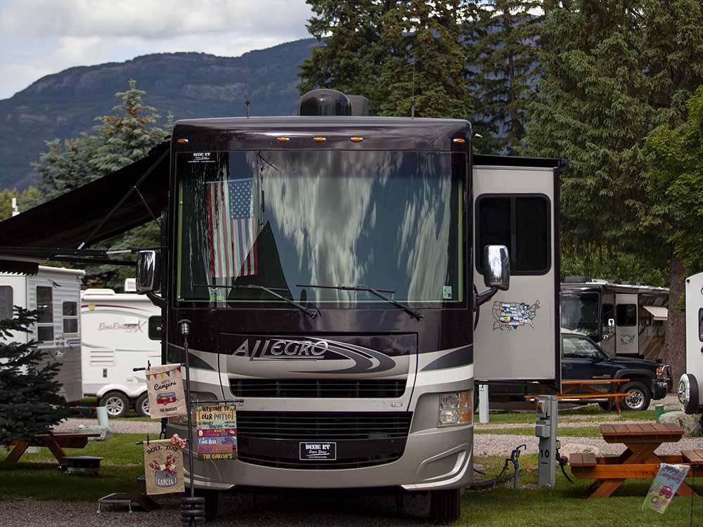 A motorhome parked in a gravel site at COLUMBIA FALLS RV PARK