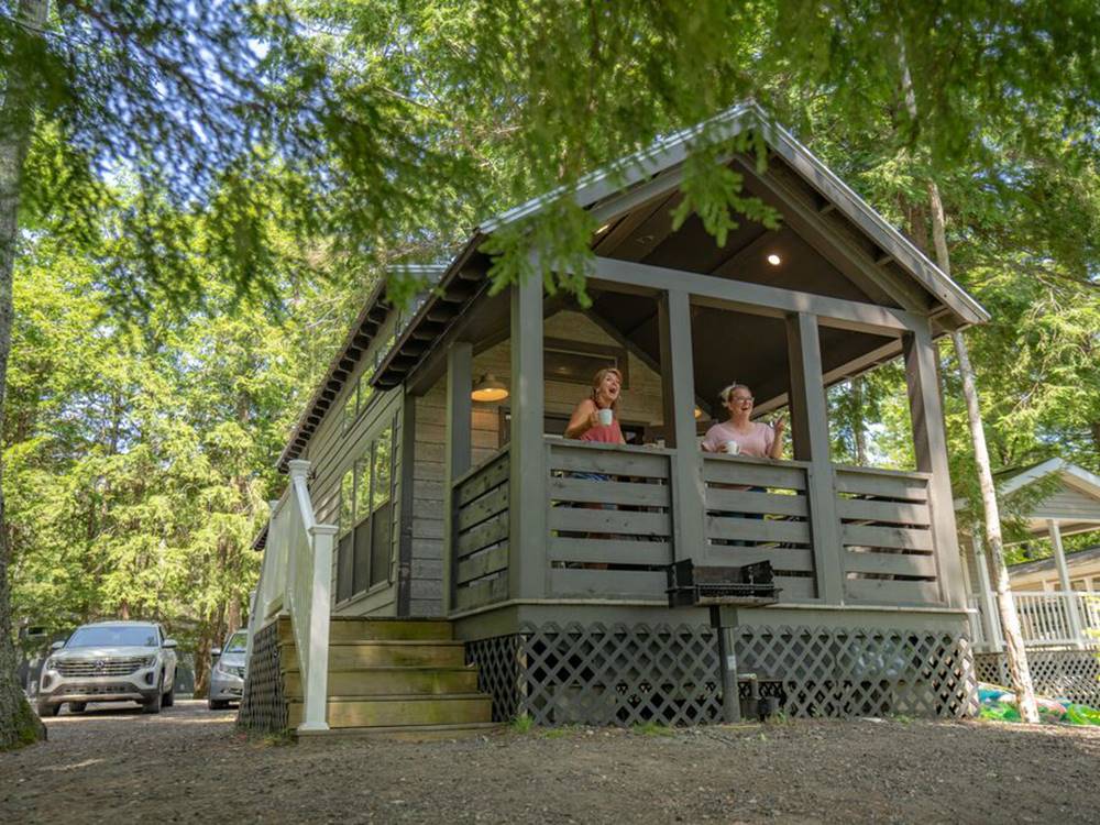 People on a porch of a cabin