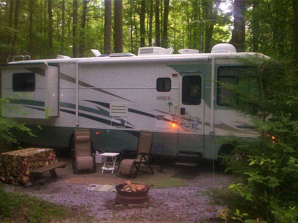 A seating area next to a motorhome at WOODSMOKE CAMPGROUND