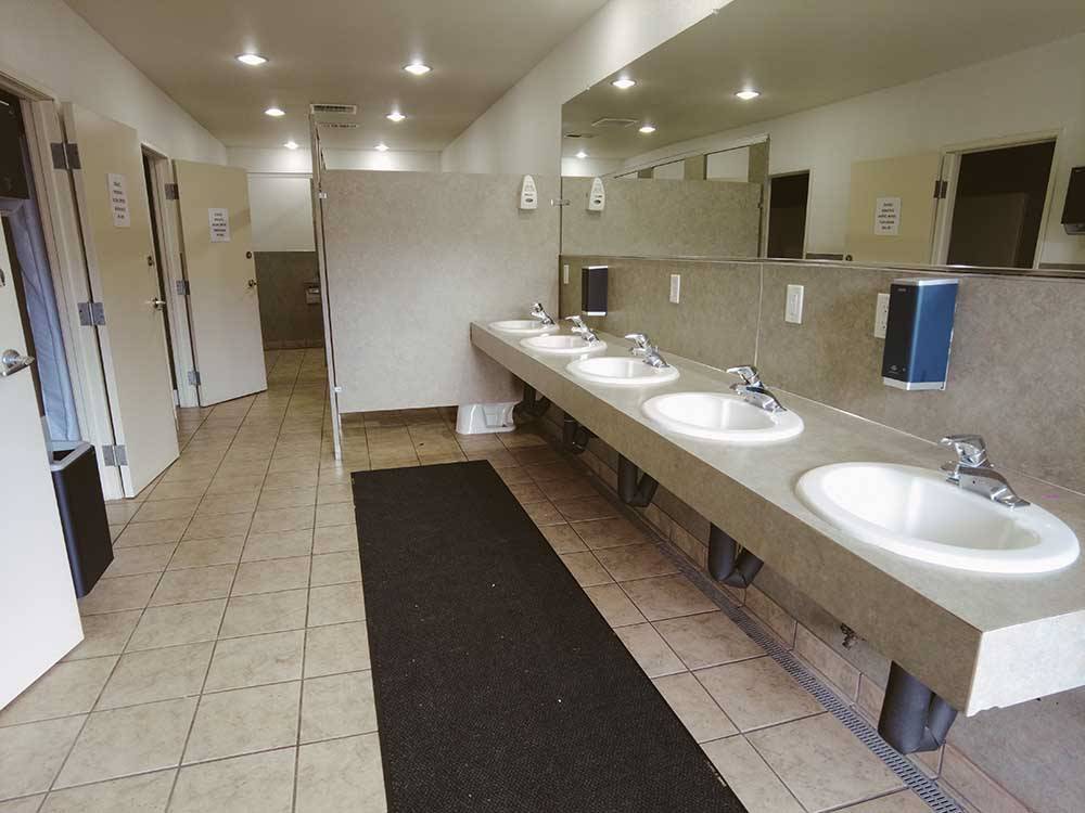 Public bathroom with five sinks at NINETY-9 RV PARK
