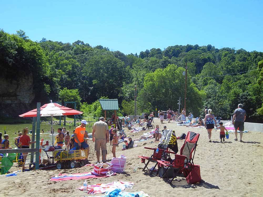 A large group of people on the beach at AUSTIN LAKE RV PARK & CABINS