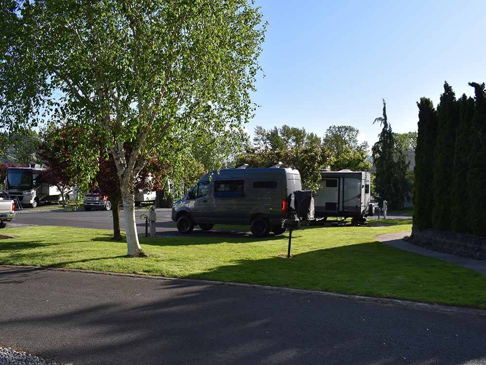 A camping van in a back in RV site at GORGE BASE CAMP RV PARK