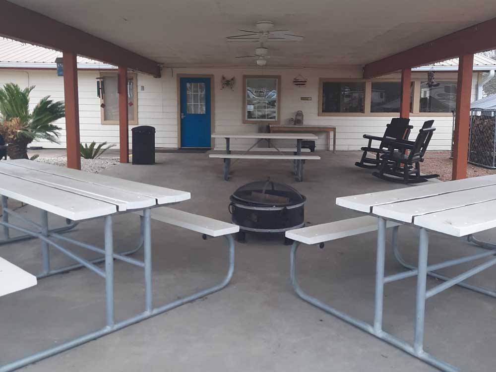 Picnic benches under the pavilion at WHISPERING OAKS RV PARK