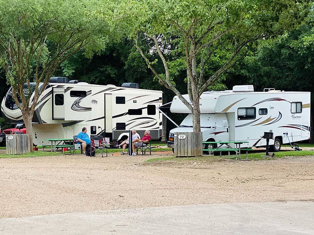 A couple of RVs in gravel sites at COLORADO LANDING RV PARK