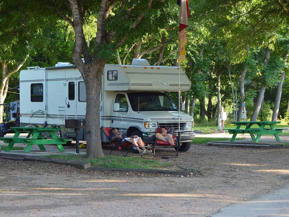 Couple camping in RV at COLORADO LANDING RV PARK
