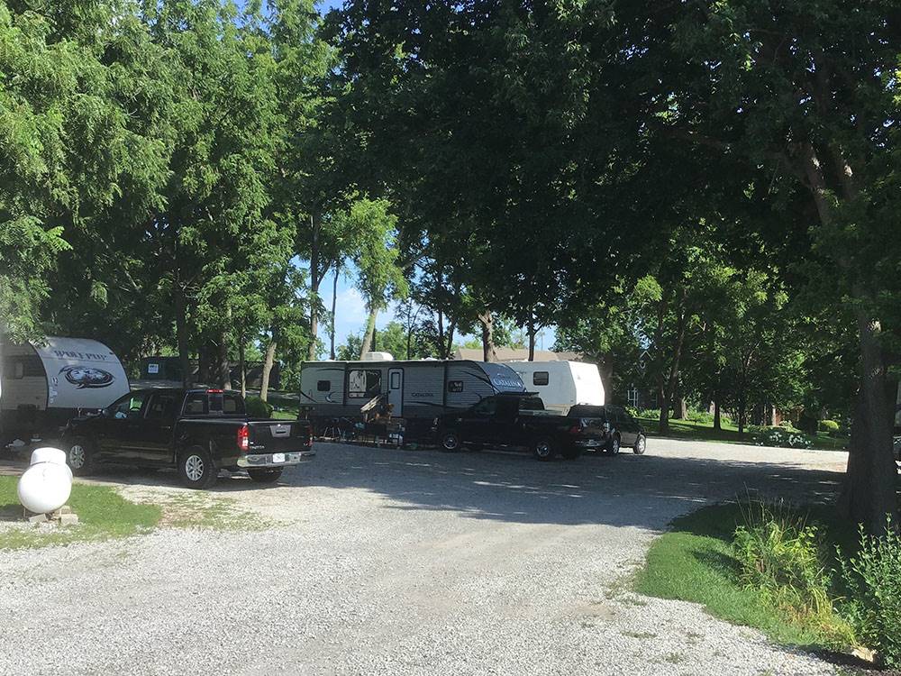 Fifth wheel trailers parked in gravel sites at SHARP RV PARK
