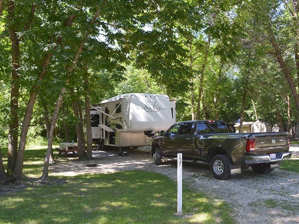 Dodge Ram truck parked in front of a fifth wheel trailer at MILLER'S CAMPING RESORT