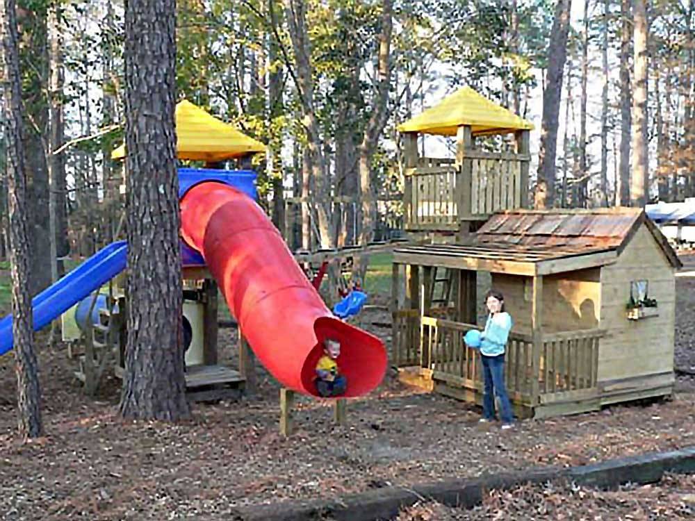 Kids playing at the playground at LAKE PINES RV PARK & CAMPGROUND