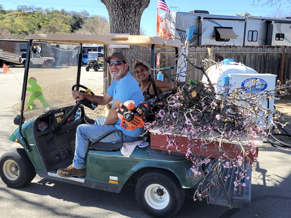 A man and woman in a golf cart at PASO ROBLES RV RANCH