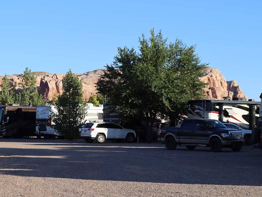 A row of motorhomes parked in gravel sites at COTTONWOOD RV PARK
