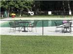 Tables and chairs outside the outdoor pool at SOUTH FORTY RV CAMPGROUND - thumbnail