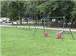 Two swing sets and teeter totter at SOUTH FORTY RV CAMPGROUND - thumbnail