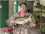 A man holding the fish he caught at GREEN ACRES FAMILY CAMPGROUND - thumbnail