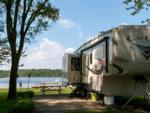 An RV parked in a site by the lake - thumbnail