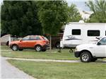 A travel trailer and vehicles parked at site at Indiana Beach Campground - thumbnail