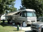 A motorhome parked in a concrete site at COUNTRY MANOR RV & MH COMMUNITY - thumbnail