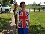 View larger image of Boy with a fish he caught at GREENVILLE FARM FAMILY CAMPGROUND image #7