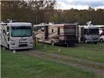 A row of motorhomes in grassy RV sites at GREENVILLE FARM FAMILY CAMPGROUND - thumbnail