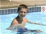 View larger image of Smiling boy in swimming pool at MOUNTAIN VISTA CAMPGROUND image #6