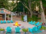 Fire pit surrounded by blue Adirondack chairs - thumbnail