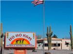 View larger image of Mobile home park entrance with American flag at HO HO KAM RV PARK image #1