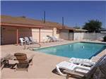 View larger image of Swimming pool with chairs and chaise lounges at HO HO KAM RV PARK image #4