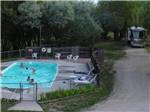 View larger image of RV camping and people enjoying the swimming pool at DEER PARK image #9