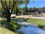View larger image of A stream running thru the campsites at OASIS RV RESORT  COTTAGES - DURANGO image #1