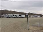A row of trailers in gravel at WESTERN HILLS CAMPGROUND - thumbnail