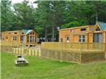 View larger image of Grass area with cabins and trees at LAKE OF THE WOODS CAMPGROUND image #6