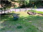 View larger image of A park bench in grass at DEAN CREEK RESORT image #9