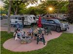 View larger image of Young family enjoying a meal on picnic bench outside of trailer at SALT LAKE CITY KOA image #4