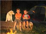 View larger image of Kids with dog roasting hotdogs at CAMP A WAY RV PARK image #8