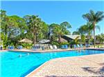 View larger image of Resort swimming pool with outdoor seating at ROYAL COACHMAN RV RESORT image #3