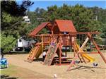The wooden playground equipment in the sand at CAPE KIWANDA RV RESORT & MARKETPLACE - thumbnail