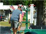 View larger image of A man playing horseshoes at PIONEER CREEK RV RESORT image #3