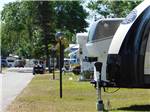 View larger image of A row of RV in campsites at PIONEER CREEK RV RESORT image #8
