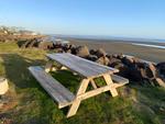A picnic table by the beach - thumbnail