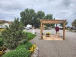 A pergola with a bench underneath at MEADOWS OF SAN JUAN RV RESORT - thumbnail