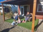 People sitting under a deck at MEADOWS OF SAN JUAN RV RESORT - thumbnail