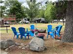 View larger image of Blue chairs arrayed in a circle near play structure at SUMMER BREEZE CAMPGROUND  RV PARK image #8