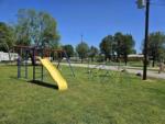 The playground in a grassy area at BOBCAT CROSSING RV COMMUNITY - thumbnail