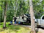 A fifth wheel trailer and truck in back in site at KALKASKA RV PARK & CAMPGROUND - thumbnail