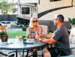 A couple playing cards next to the trailer at SAN DIEGO RV RESORT - thumbnail