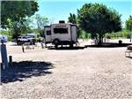 A trailer parked in a gravel site at CHEYENNE RV RESORT BY RJOURNEY - thumbnail